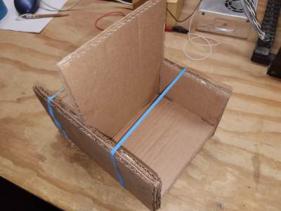 cardboard parts held in position with rubber bands