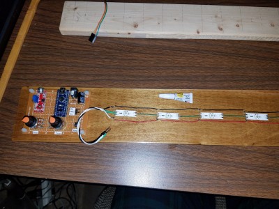 using super glue to attach the LEDs to the wood board